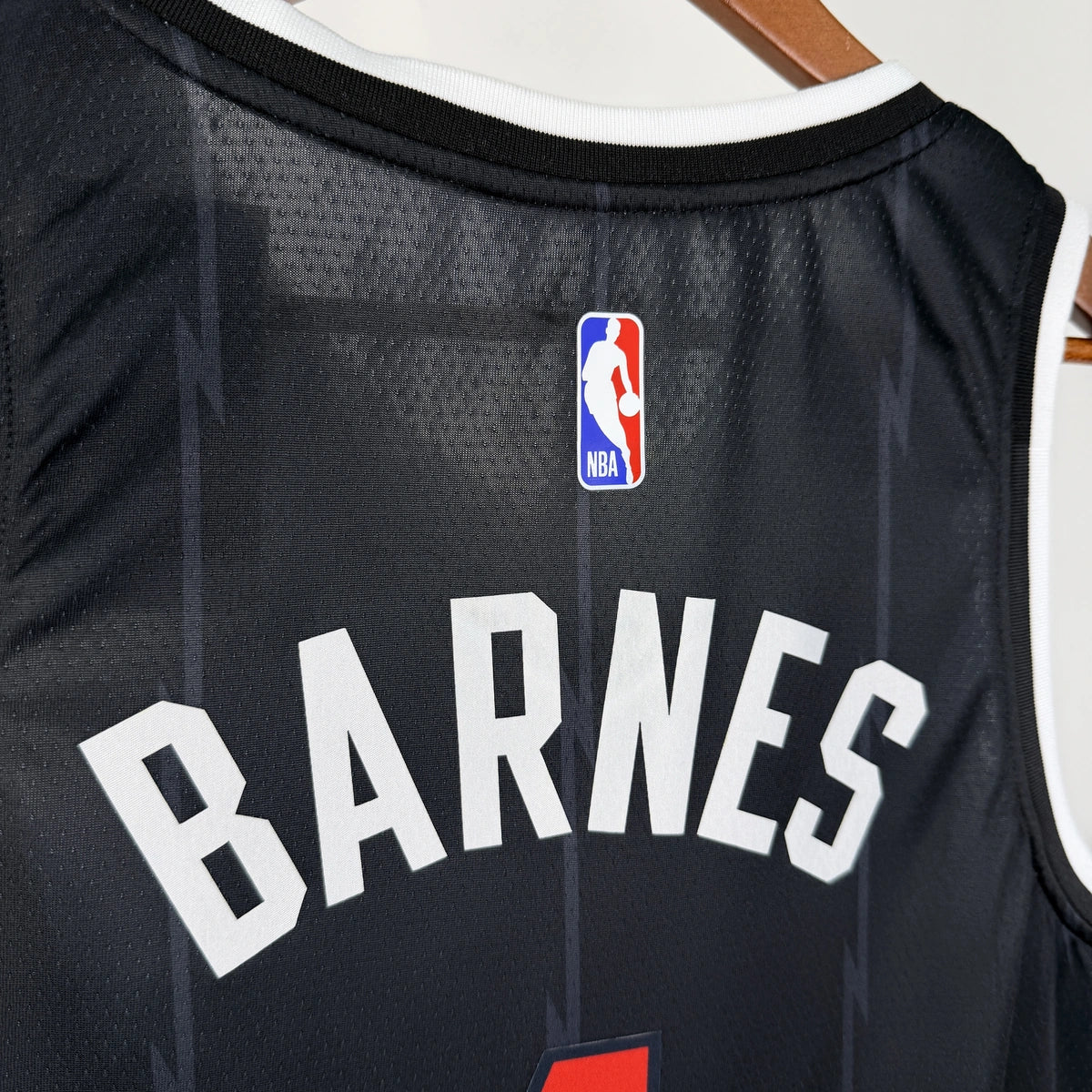 Toronto Raptors 2025-26 city edition basketball jersey close-up of jock tag and hem details in team colors for basketball fans