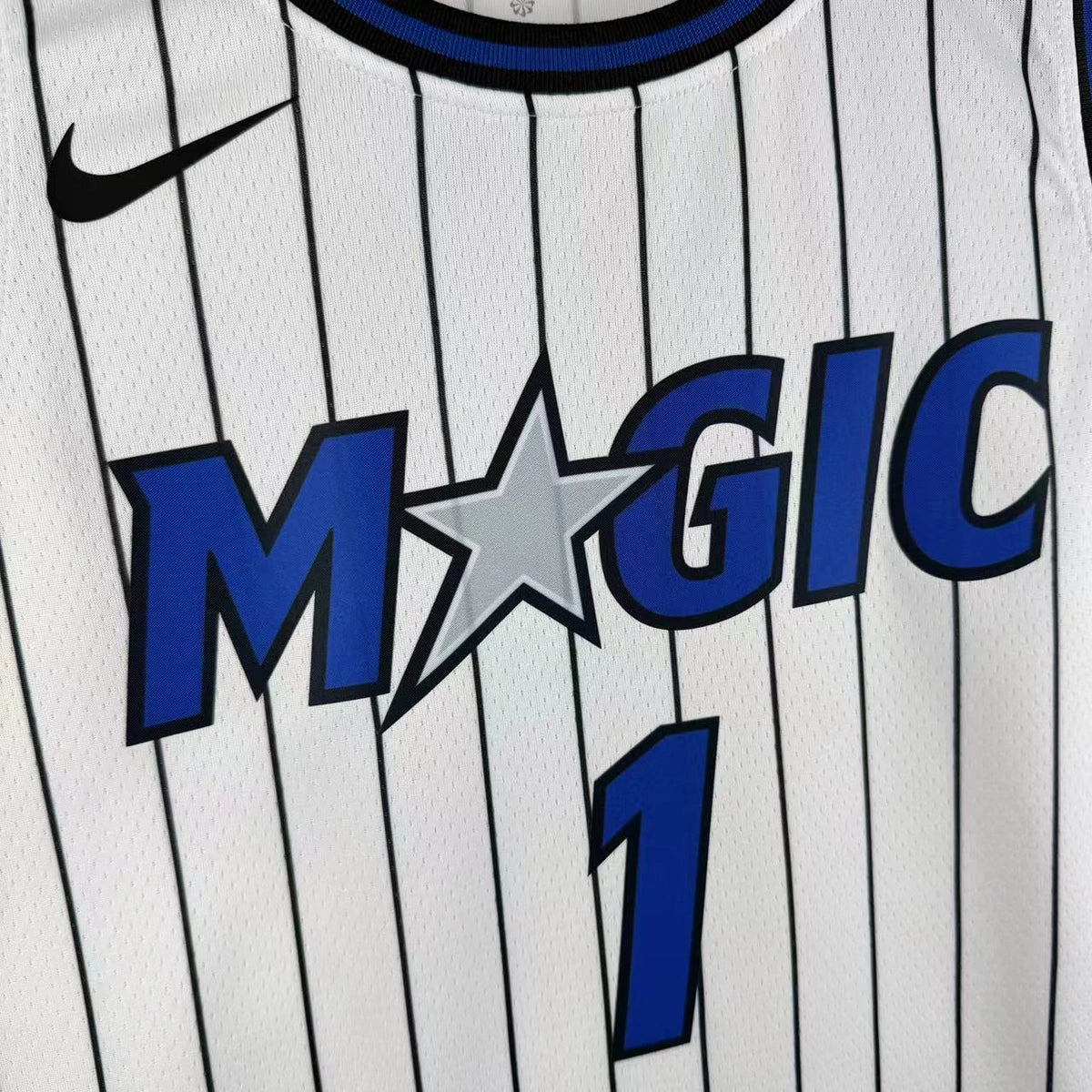 Orlando Magic 2025-26 away basketball jersey close-up of moisture-wicking fabric texture in blue for basketball fans